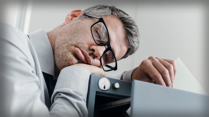 Man falling asleep at work
