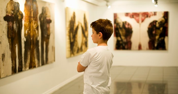 Boy looking at artwork