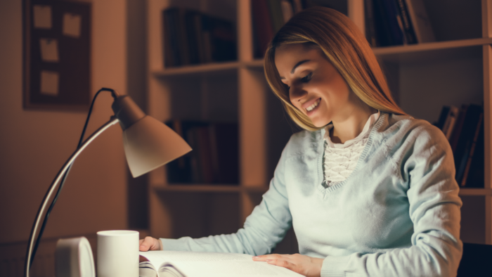 Woman Using Full Spectrum Light Bulb to Read
